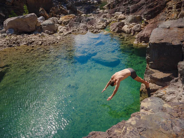 Turkey travel, mediterranean area on a warm summer day. Young man dive and have fun in mountain river. Concept of living open air, Travel , active lifestyle, summer vacation.