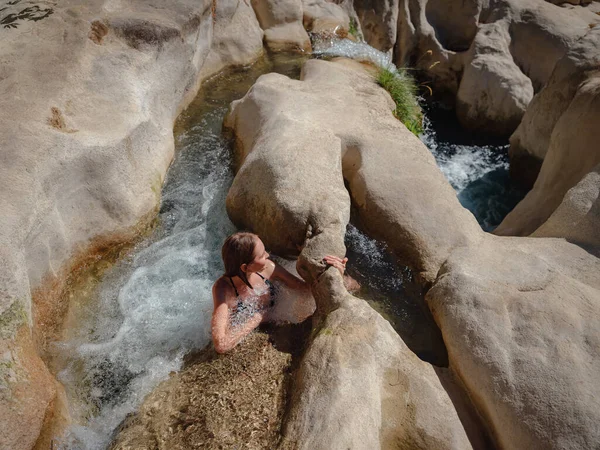 Turkey travel, mediterranean area on a warm summer day. Young woman in swimsuit have fun in mountain river. Concept of living open air, Travel , active lifestyle, summer vacation, Friluftsliv