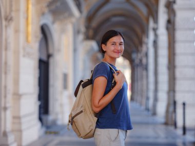 summer female solo trip to Europe, happy young woman walking on european street of Vienna, Austria