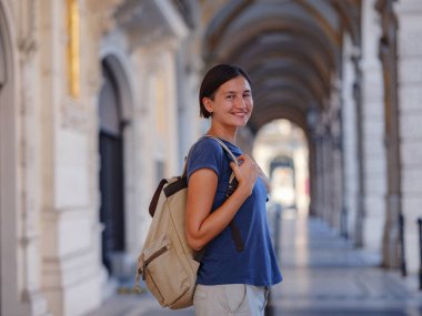 summer female solo trip to Europe, happy young woman walking on european street of Vienna, Austria