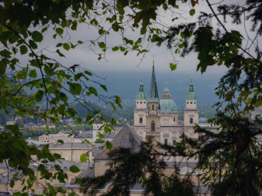Salzburg Austria inner city with churches. Beautiful view of Salzburg skyline with Festung Hohensalzburg in cloudy summer, Salzburg, Salzburger Land, Austria