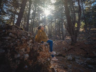 caucasian woman enjoys being in nature, beautiful forest in mountains. embracing fresh air and engaging in outdoor activities. Friluftsliv concept means spending as much time outdoors as possible
