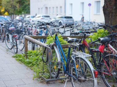 Munich, Germany - August 4, 2022 : bikes on the parking in city center. traffic, city transport and people concept