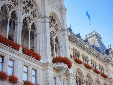 Scenic view of Viena capital, impressive gothic architecture of City hall or Rathaus . Travel and landmarks of Austria, details and flowers and flag of EU on buildings