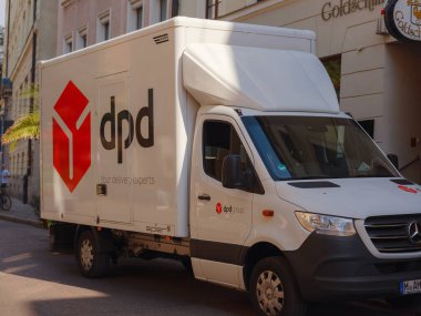Munich, Germany - August 5, 2022 : Parked DPD Courier Delivery Van over downtown. DPDgroup is an international parcel delivery service with an extensive network in UK.