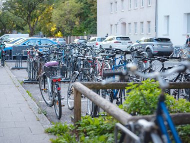 Munich, Germany - August 4, 2022 : bikes on the parking in city center. traffic, city transport and people concept