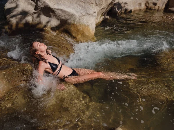 Turkey travel, mediterranean area on a warm summer day. Young woman in swimsuit have fun in mountain river. Concept of living open air, Travel , active lifestyle, summer vacation, Friluftsliv