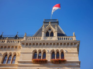 Scenic view of Viena capital, impressive gothic architecture of City hall or Rathaus . Travel and landmarks of Austria, details and flowers and flag of Vienna on buildings