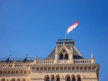 Scenic view of Viena capital, impressive gothic architecture of City hall or Rathaus . Travel and landmarks of Austria, details and flowers and flag of Vienna on buildings