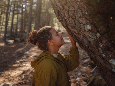 caucasian woman enjoys being in nature, beautiful forest in mountains. embracing fresh air and engaging in outdoor activities. Friluftsliv concept means spending as much time outdoors as possible