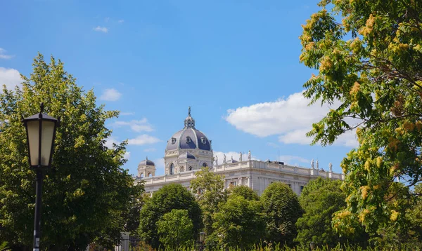 stock image Summer Travel to capital of Austria Vienna. Museum of Art History or Kunsthistorisches Museum in Vienna. view through the greenery of the park