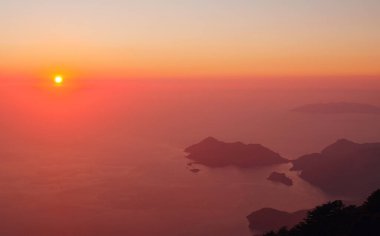 Summer scenery of Blue Lagoon with white sand located in city Oludeniz. Beautiful view on summer sea and town from top moutain. Sunset time