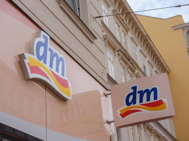 Vienna, Austria - August 8, 2022: Logo of dm store. dm-drogerie markt is a chain of retail stores that sells cosmetics, healthcare items, household products and health food.