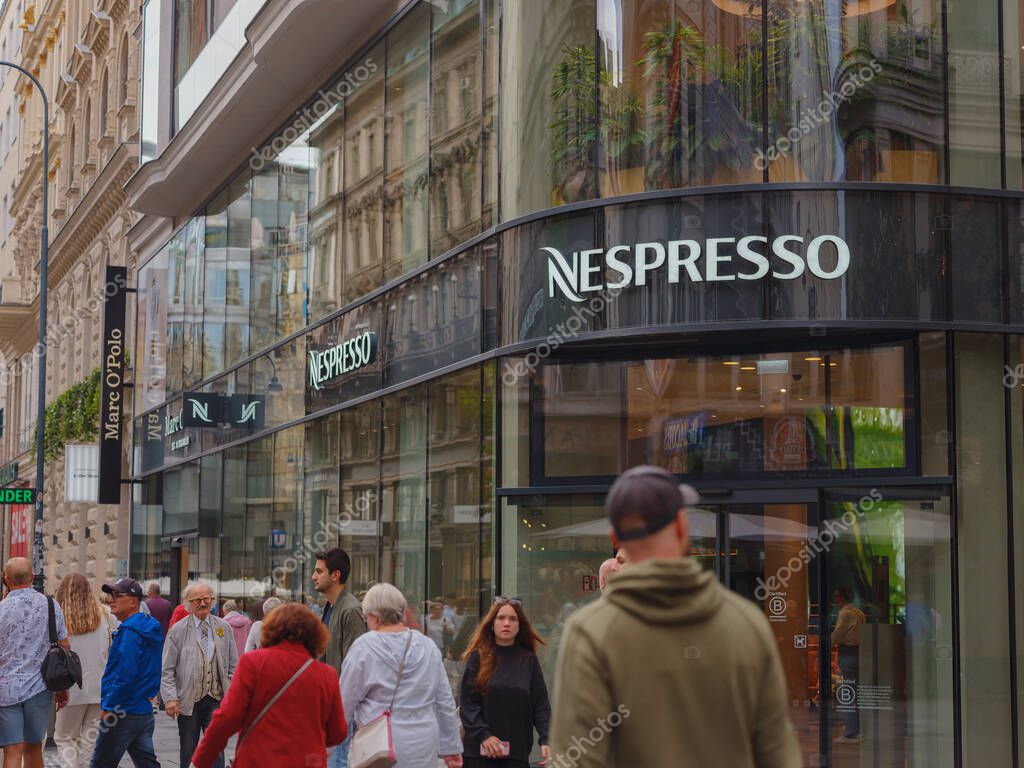 Vienna, Austria - August 8, 2022: Nespresso store logo on a shopping street. Nespresso machines brew espresso and coffee from coffee capsules, or pods.