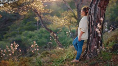 caucasian woman enjoys being in nature, beautiful forest in mountains. embracing fresh air and engaging in outdoor activities. Friluftsliv concept means spending as much time outdoors as possible