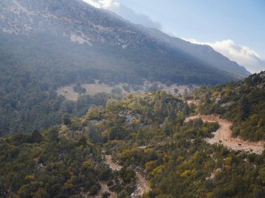 Sunset light over hills around of the Babadag mountain Turkey with herd of goats , sunset view. Wide landscape with mountains and beautiful clouds on top viewpoint in Fethiye.