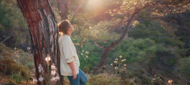 caucasian woman enjoys being in nature, beautiful forest in mountains. embracing fresh air and engaging in outdoor activities. Friluftsliv concept means spending as much time outdoors as possible