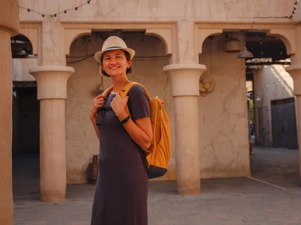 stock image tourist trip to old Dubai, UAE. Asian Woman tourist in old narrow streets of Bur Dubai and Creek, Al Seef Heritage Souq. Travel and sightseeing journey concept