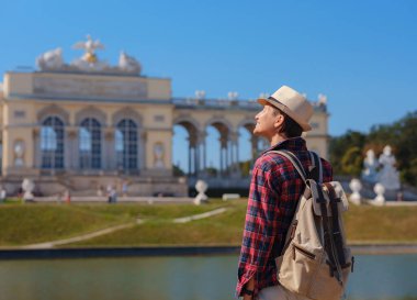 summer female solo trip to Europe, happy young woman walking , Schonbrunn Palace in Vienna, Austria