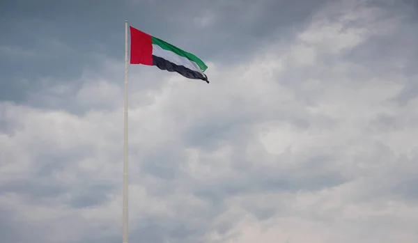 United Arab Emirates flag flying against sky. UAE celebrates it\'s national day on 2nd December every year. Emirates Heritage Club Heritage Village