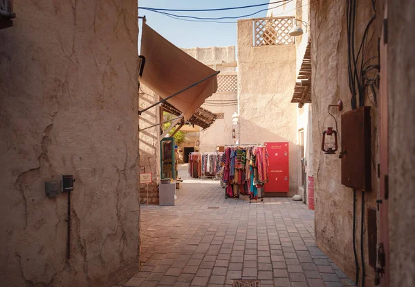 stock image 20 March 2023, Dubai, UAE: Al Seef old town village in Dubai, traditional old souk with dresses and other wearings.