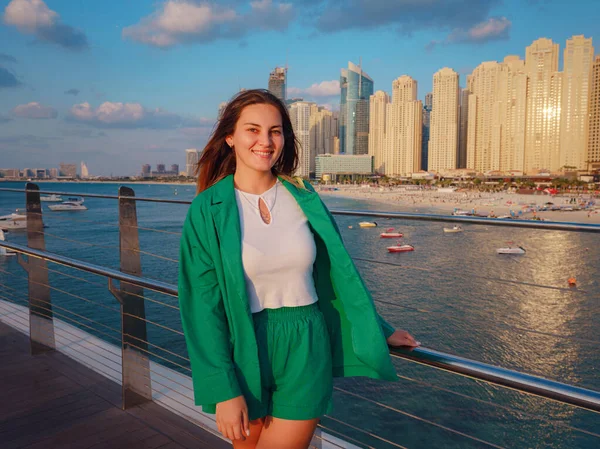 身穿绿色西服的年轻女子走在迪拜的街道上 迪拜滨海区蓝水岛 阿拉伯联合酋长国之行概念 成功的出国 移居他国 工作签证的想法 — 图库照片
