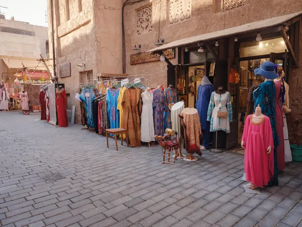 stock image 20 March 2023, Dubai, UAE: Al Seef old town village in Dubai, traditional old souk with dresses and other wearings.