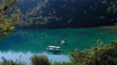 Trekking from Oludeniz to Fethiye, Lycian trail. travel in Turkey. active vacations healthy lifestyle eco tourism. two boats are parked in a beautiful bay