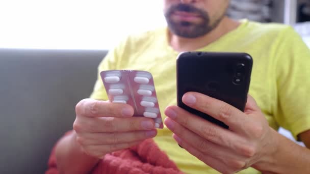 Man Using Smartphone Studies Instructions Taking Pills Sick Guy Sits — Stock Video