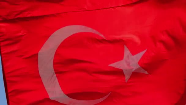 在蓝天和云彩的背景下 土耳其的大而明亮的国旗在高高的地面上飘扬 风力很强 — 图库视频影像