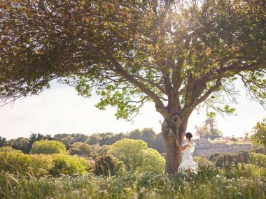Beyaz elbiseli güzel Asyalı genç kadın. Rodos Akropolü. Stadyum ve tiyatro gibi çeşitli binalarla antik yerleşim yerlerinin ünlü kalıntıları..
