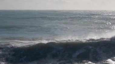 Akdeniz, Konyaalti, Antalya ve Türkiye 'de güçlü dalgalar hakim. Fırtınalı dalgalar köpüklü köpüklü deniz, mavi gökyüzü.