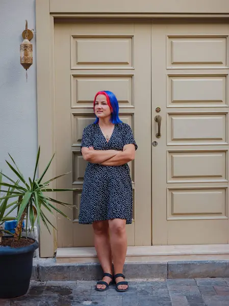 female summer old town walk in Antalya Turkey. woman with colorful hair and dress gracefully explores its historic streets. creating visual symphony that harmonizes past and present.