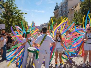 Prague, Czech Republic - August 12, 2023: Prague Pride Festival Parade. Women and men with colorful balloons playing musical instruments during gay pride clipart