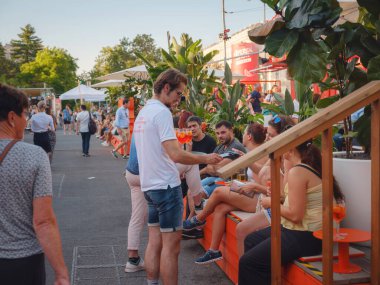 Viyana, Avusturya - 17 Temmuz 2023. Viyana Film Festivali, Avrupa 'nın en büyük kültürü, mutfak festivali. Viyana 'nın ana meydanındaki sinema ve restoranlardan hoşlanan insanlar, belediye binasının yanındaki Rauthausplatz.