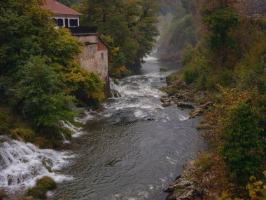 Travel to Village of Rastoke near Slunj in Croatia. Breathtaking view old water mills on waterfalls of Korana river, beautiful countryside landscape clipart