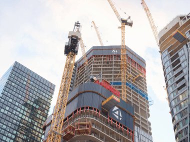 Frankfurt, Germany - May 16, 2023: view of the construction of a skyscraper in the center of the city, a developing business center in evening light in Frankfurt clipart