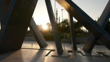 Gün batımında Wahat Al Karama Parkı 'ndan huzurlu bir manzara. Altın ışık, huzurlu manzaranın üzerine sıcak bir ışık saçıyor. İkonik Şeyh Zayed Camii arka planda güzel duruyor ve nefes kesici bir manzara yaratıyor..