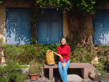 Tourist woman enjoys historic charm of Hochst near Frankfurt, wandering through picturesque streets with old houses and cobblestone alleys, soaking in peaceful atmosphere of old town. clipart