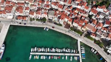 Baska plajı ve kristal berraklığında turkuaz su, marina botları, şehir sokağı, Krk Adası 'ndaki insansız hava aracından yakalanan güneşli yaz havası. Adriyatik Denizi 'ndeki Baska Tatil Kasabası