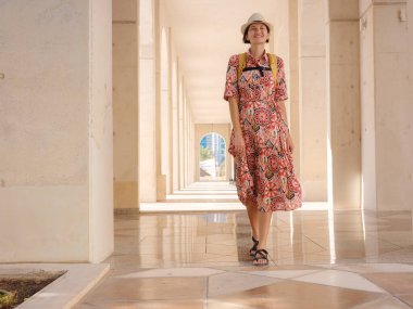 Abu Dabi 'de Qasr Al Hosn Parkı' nı keşfeden genç bir kadın. Yeşillik ve tarihi simgelerle çevrelenmiş, kentin kalbindeki sakin atmosfer ve Emirati mirasının tadını çıkarıyor..