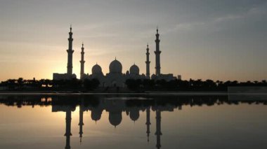 Abu Dabi 'deki Şeyh Zayed Camii' nin günbatımının çarpıcı manzarası. Büyük mimari, dingin atmosfer onu BAE 'deki İslam kültürünün ve ruhaniliğin dikkate değer bir sembolü yapıyor. Wahat Al Karama 'dan görüntü