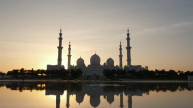 Abu Dabi 'deki Şeyh Zayed Camii' nin günbatımının çarpıcı manzarası. Büyük mimari, dingin atmosfer onu BAE 'deki İslam kültürünün ve ruhaniliğin dikkate değer bir sembolü yapıyor. Wahat Al Karama 'dan görüntü