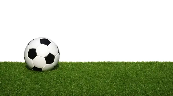 Soccer ball on green grass isolated on white