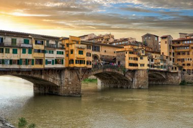 Gün batımında Floransa 'daki Arno Nehri' nde Ponte Vecchio Köprüsü 'nün Corridoio Vasariano' suyla çekilmiş resmi bir şehir manzarası. Toskana, İtalya                               