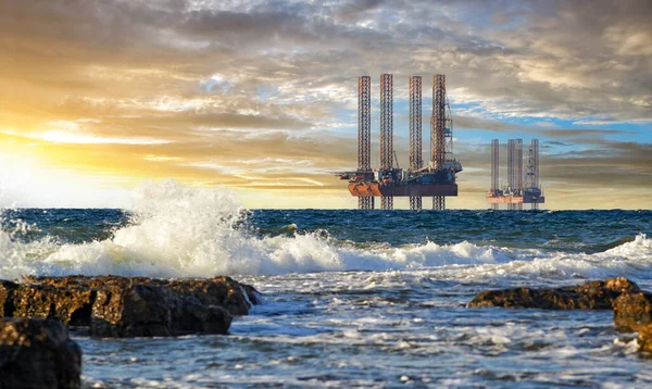 Ukrainian gas drilling rigs produce gas on the Black Sea shelf in western Crimea before the 2014-2022 war. Drilling platforms in the sea at sunset. Peninsula Tarkhankut, Crimea, Ukraine