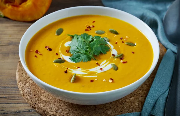 bowl of pumpkin soup on kitchen table