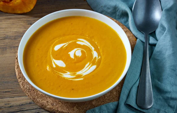 bowl of pumpkin soup on kitchen table