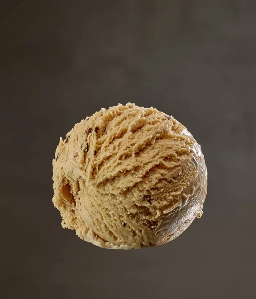 caramel ice cream ball on grey background