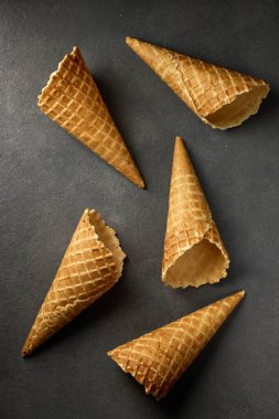 waffle ice cream cones on dark grey background, top view